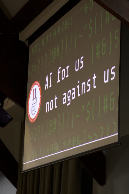 A slide from Jon Schleuss's keynote: "AI for us, not against us."